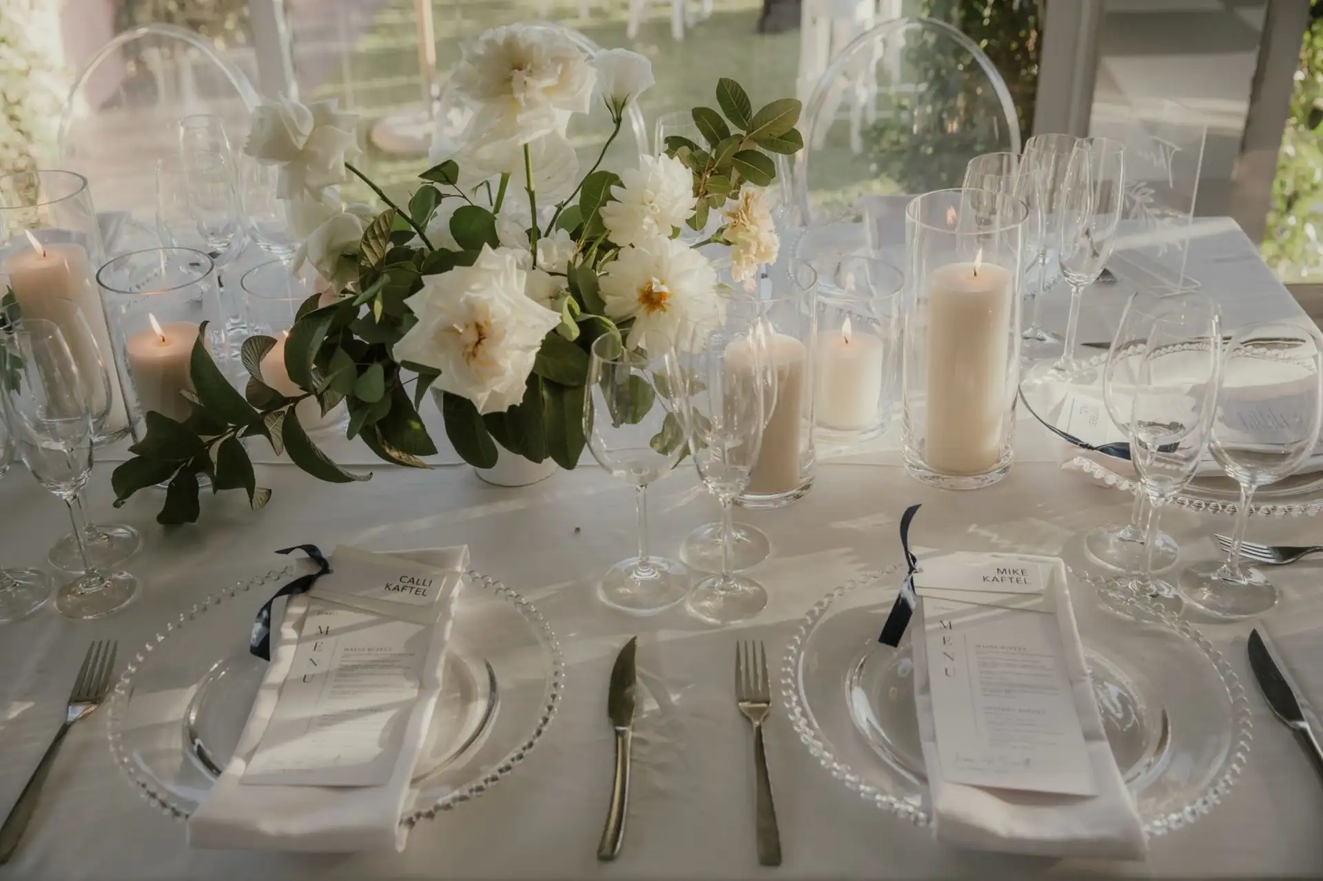 Printed menus and place cards set on charger plates at a wedding reception