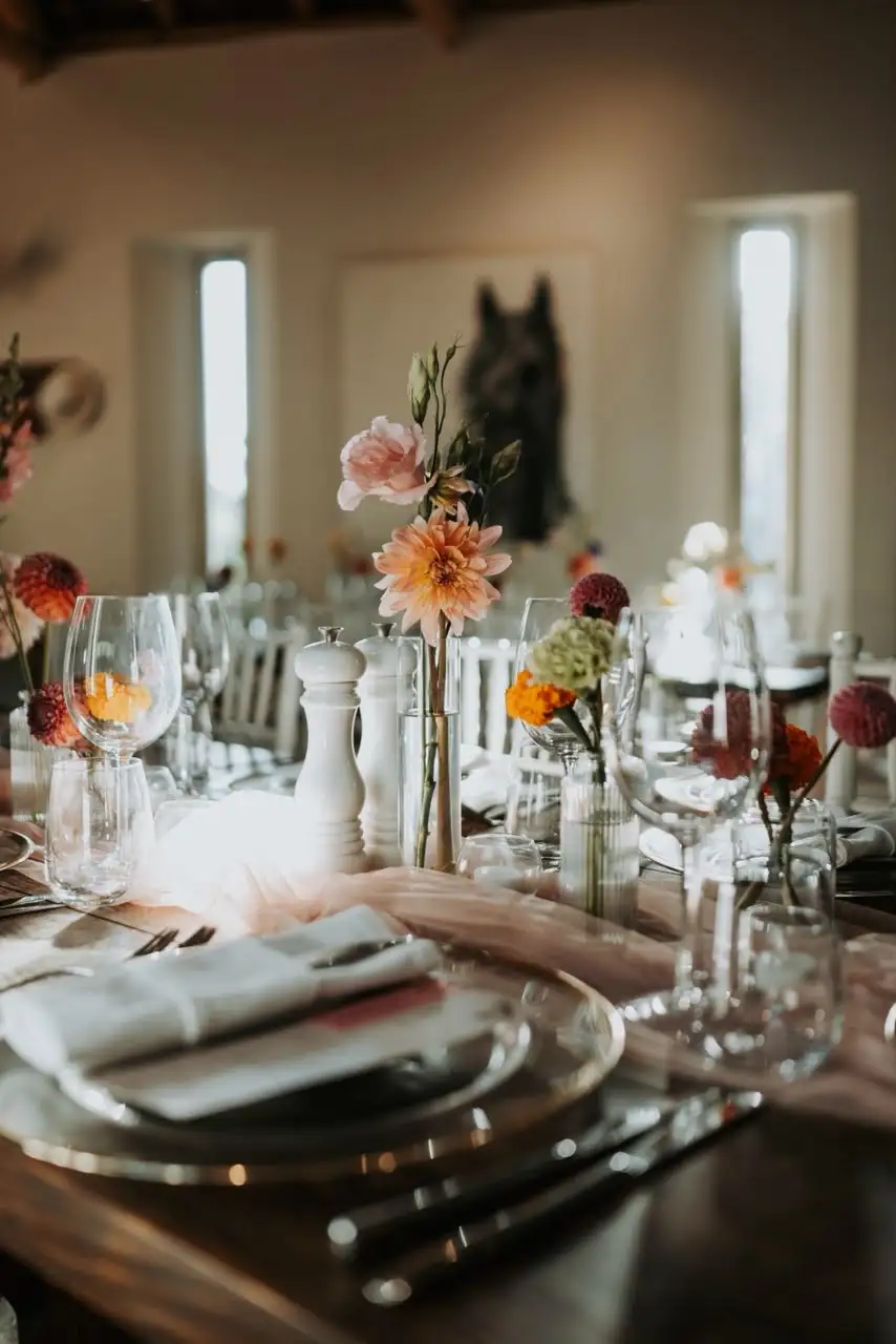 Autumn-toned reception table set with florals, candles and menus